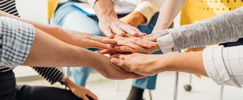 Business team standing hands together