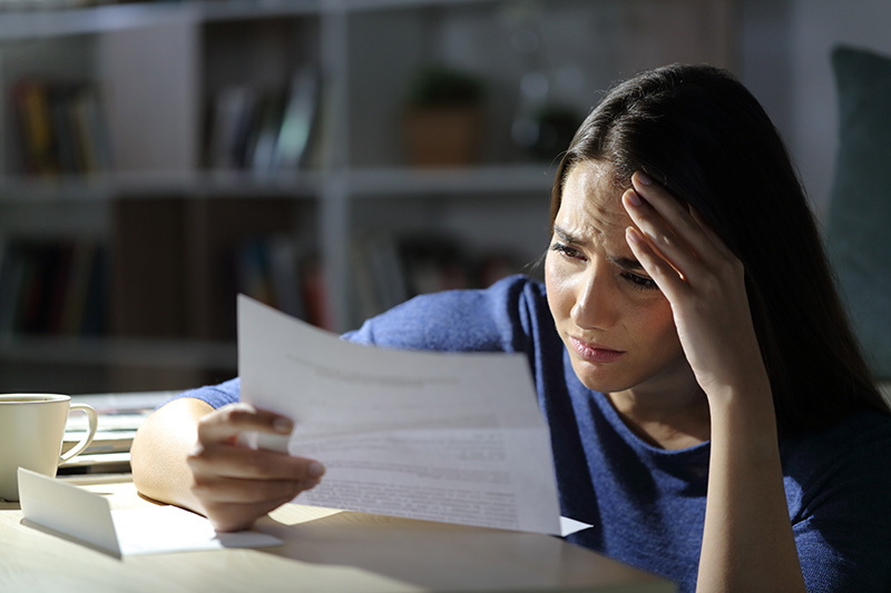 Woman distressed while reading letter