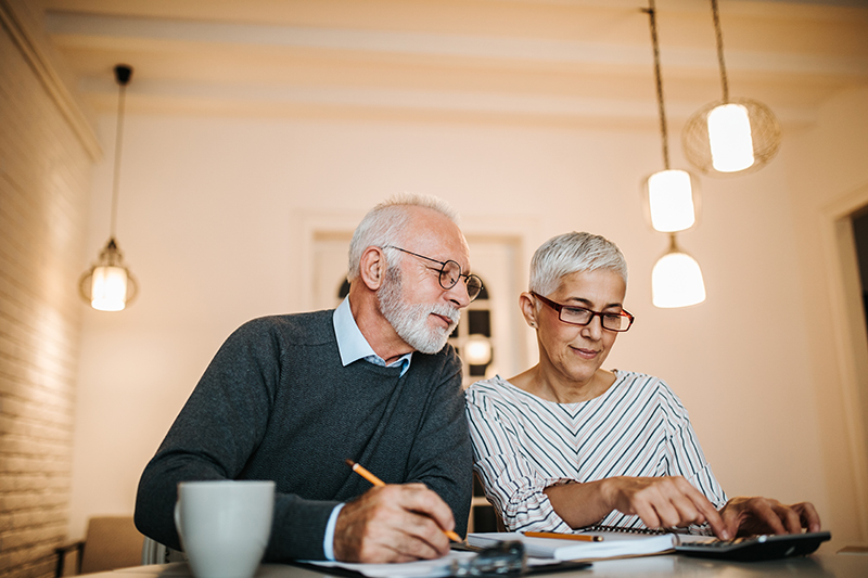 Elderly couple looking over paperwork