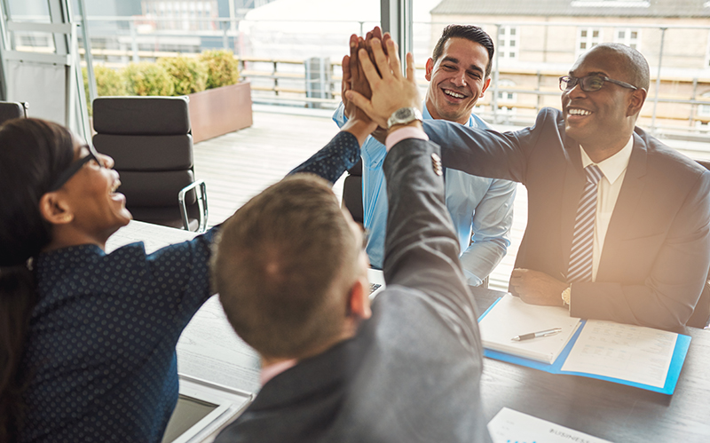 Professionals giving high fives