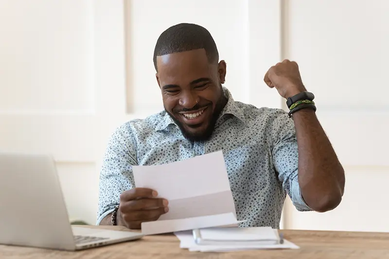 Man happily reading a letter