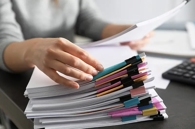 Woman's hand rifling through paperwork