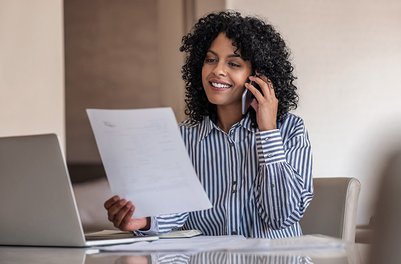 IRS Agent Holding Paperwork and on the Phone