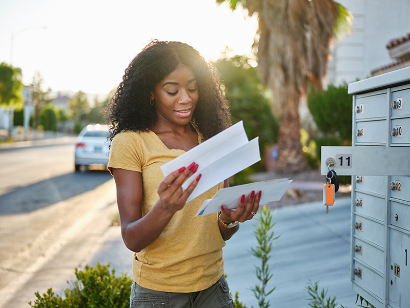 Woman looking at her mail with a smile